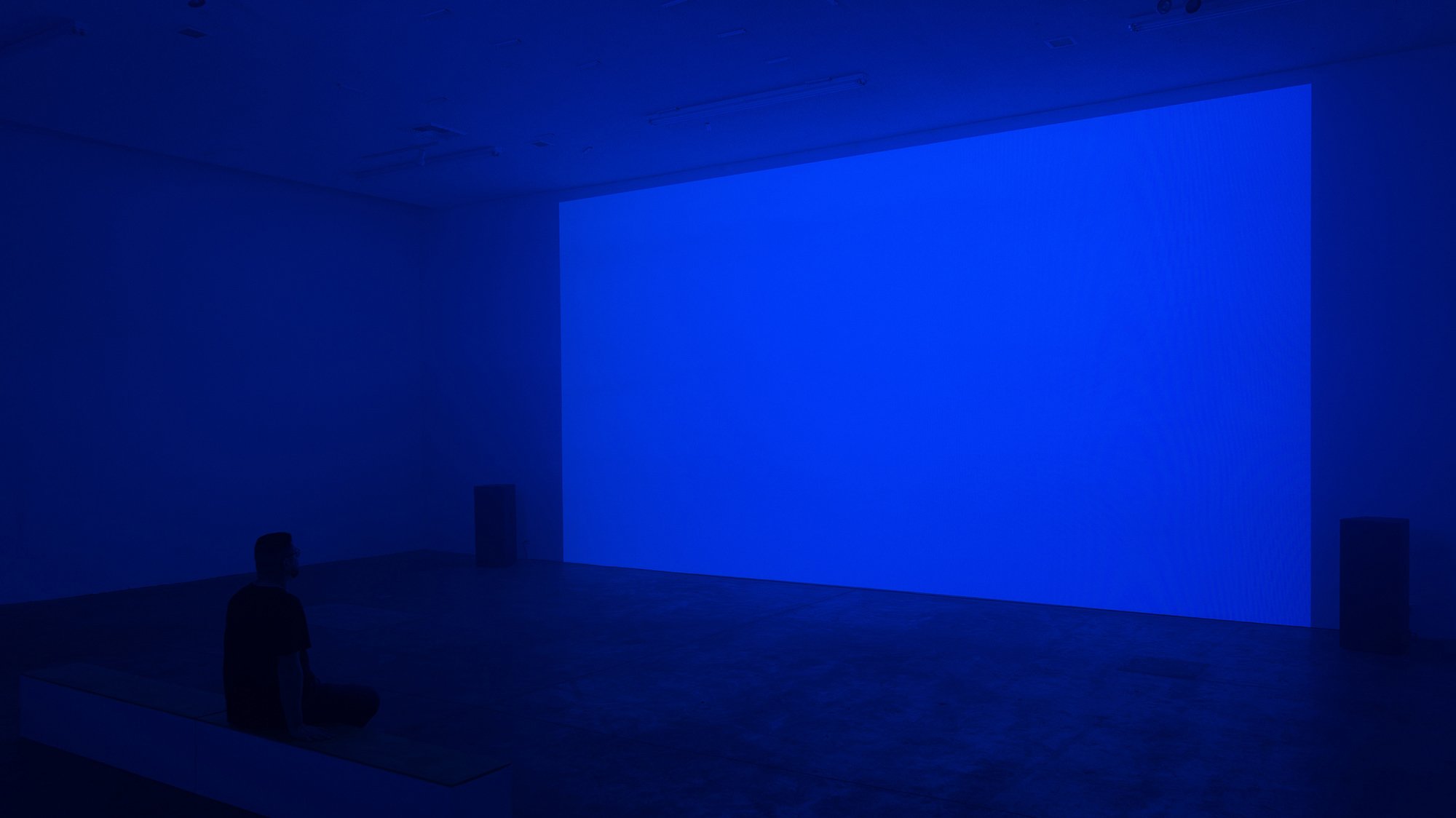 Repose Installation (blue with figure sitting on bench)