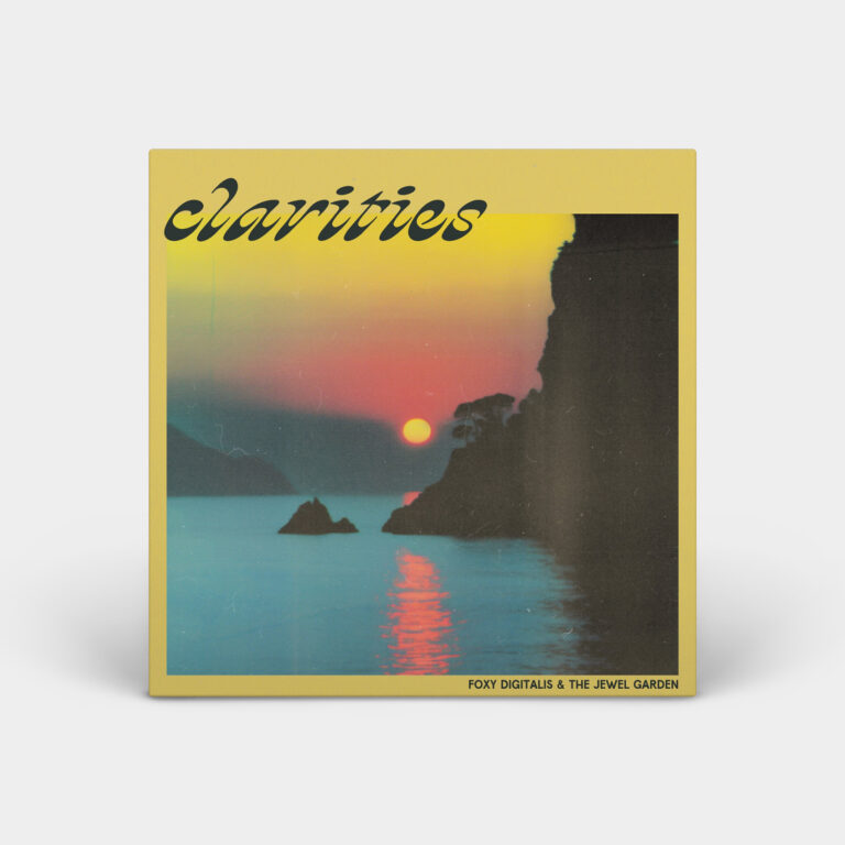 Album cover made to look 3d on a light grey background with shadows below it. The cover is yellow with photo of a sunset over water with a cliff wall in shadow on the right. The sunset is pink and yellow and the sun is reflecting orange/pink in the water. Text in the upper right corner reads “Clarities’ and text on the bottom left reads “Foxy Digitalis & The Jewel Garden”.